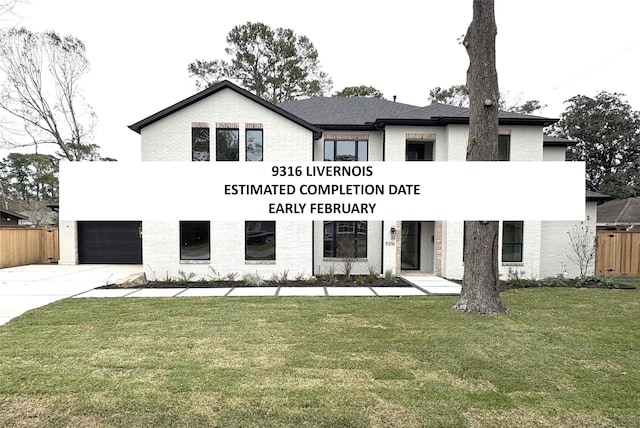 view of front of house featuring a garage and a front yard