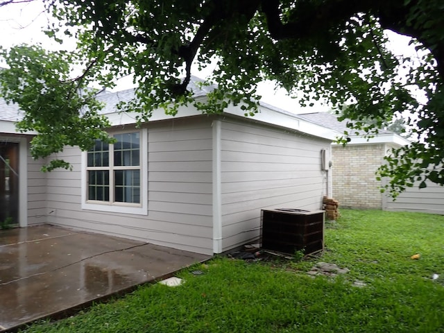 back of house featuring a patio area, central air condition unit, and a lawn