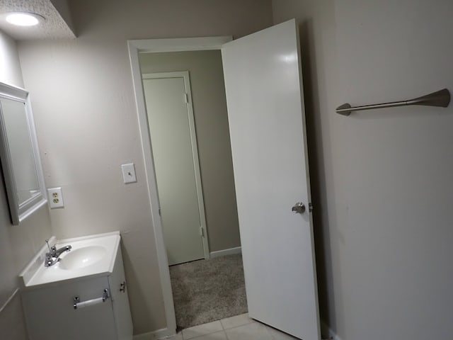 bathroom with tile flooring and large vanity