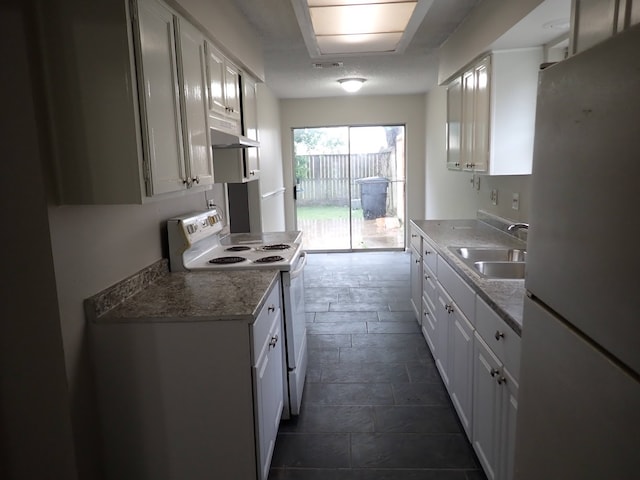 kitchen featuring white appliances, white cabinets, sink, and light stone countertops