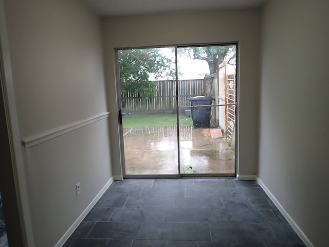 entryway with dark tile flooring