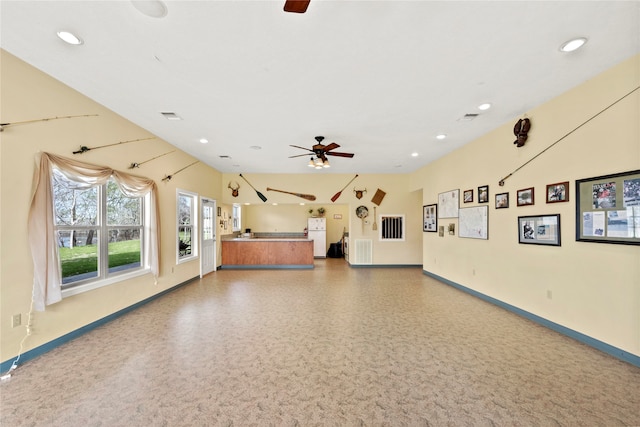 interior space with ceiling fan