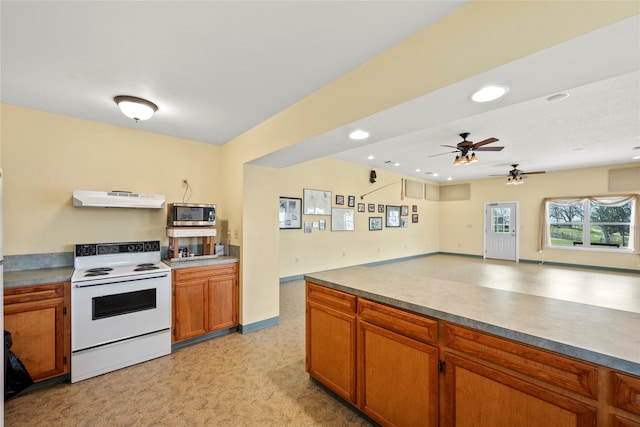 kitchen with white range with electric cooktop, ceiling fan, and light colored carpet