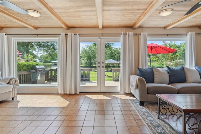 doorway to outside with plenty of natural light, beam ceiling, and french doors