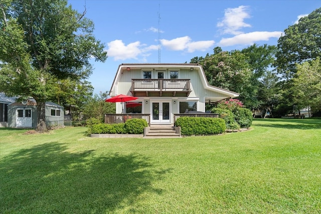 view of front of house with a front yard and a balcony