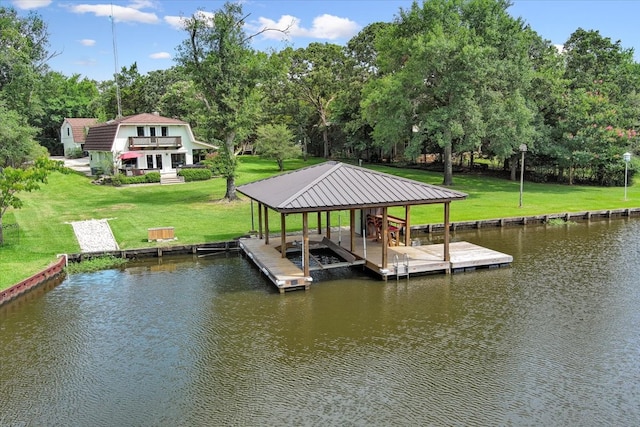 view of dock featuring a water view and a yard