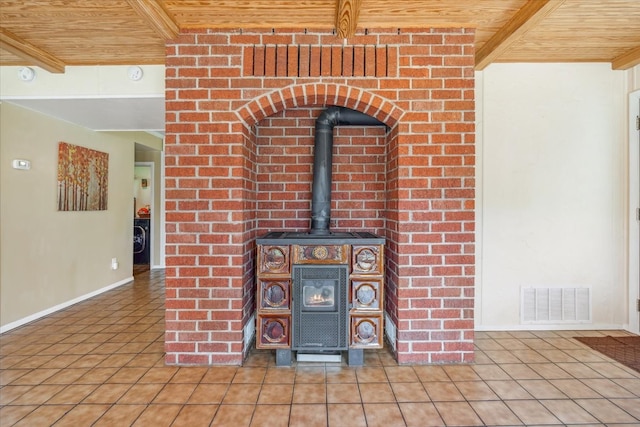 details with tile floors, beam ceiling, and a wood stove