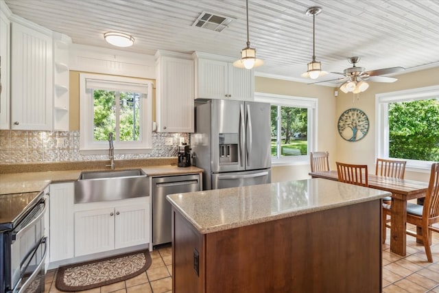 kitchen with appliances with stainless steel finishes, backsplash, and plenty of natural light