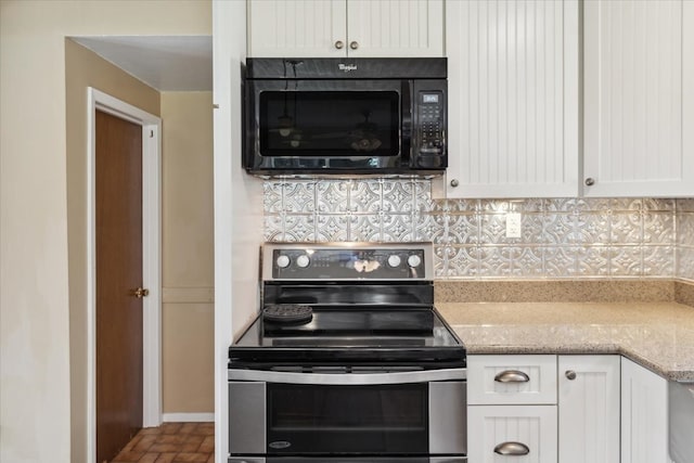 kitchen with white cabinetry, light stone countertops, backsplash, and stainless steel electric range oven