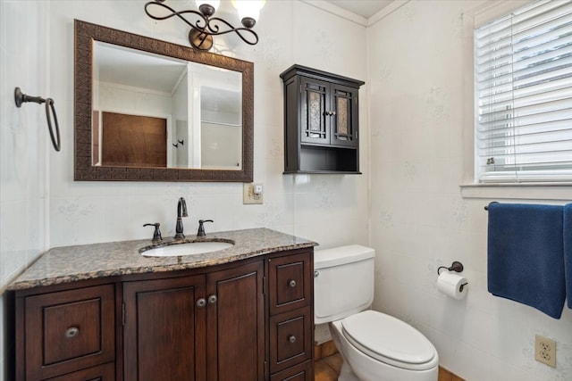 bathroom featuring tile walls, vanity, and toilet