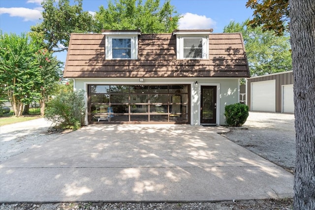 view of front of house featuring an outdoor structure and a garage