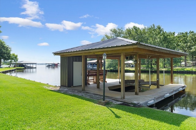 dock area with a yard and a water view