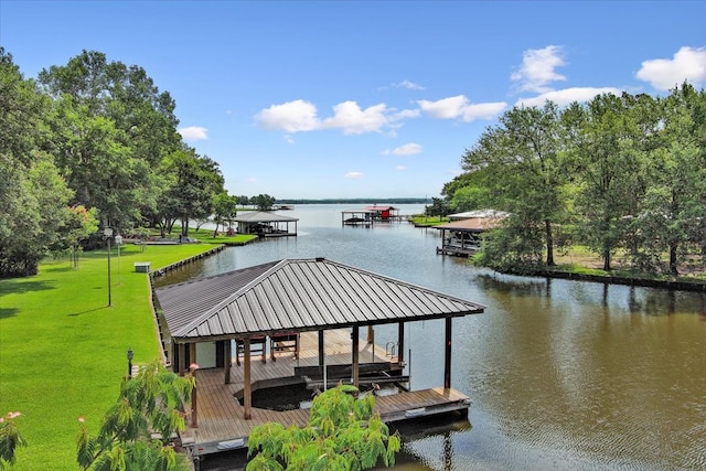 view of dock featuring a water view and a yard