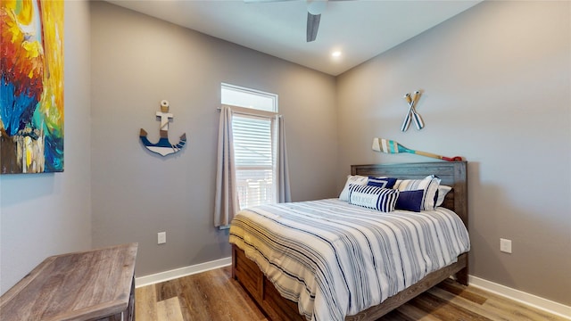 bedroom with ceiling fan and hardwood / wood-style floors