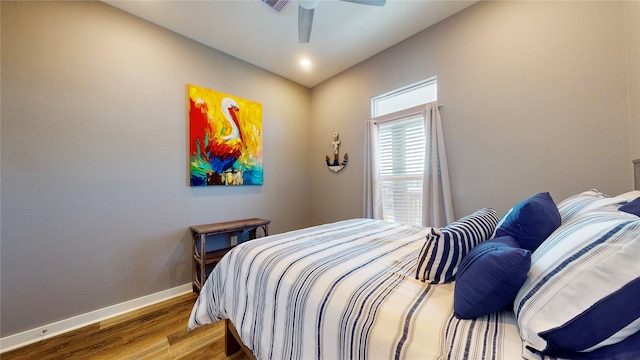 bedroom featuring hardwood / wood-style flooring and ceiling fan