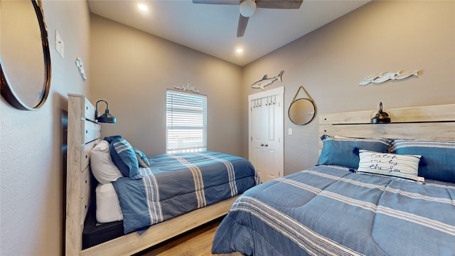 bedroom with hardwood / wood-style floors, ceiling fan, and a closet