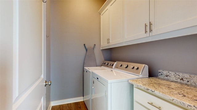 laundry area with cabinets, separate washer and dryer, and dark hardwood / wood-style floors