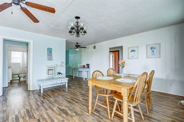 dining area with ceiling fan with notable chandelier, a textured ceiling, and hardwood / wood-style flooring