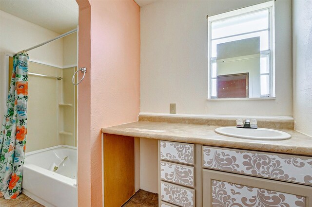 bathroom with tile floors, plenty of natural light, shower / bath combo with shower curtain, and vanity