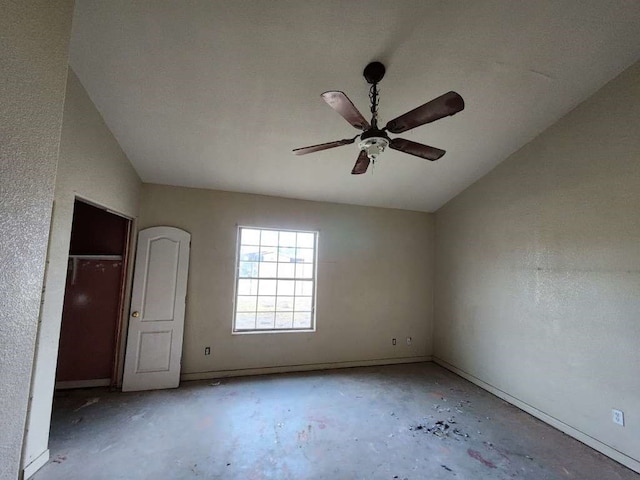 unfurnished bedroom with vaulted ceiling, a closet, ceiling fan, and concrete flooring