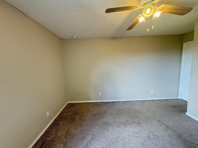 carpeted empty room featuring a textured ceiling and ceiling fan