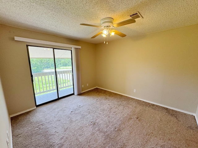 spare room featuring carpet flooring, ceiling fan, and a textured ceiling