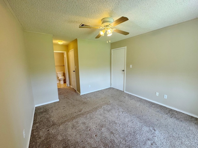 carpeted spare room with ceiling fan and a textured ceiling