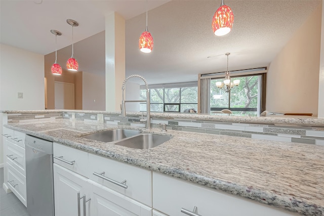 kitchen with tasteful backsplash, light stone countertops, stainless steel dishwasher, white cabinetry, and a sink