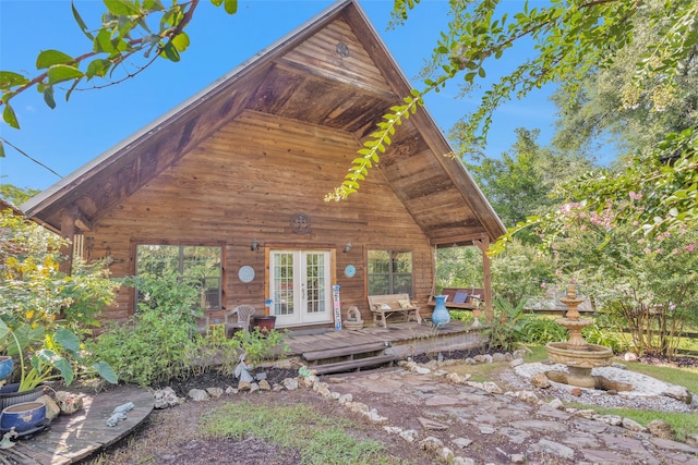 cabin with a wooden deck and french doors