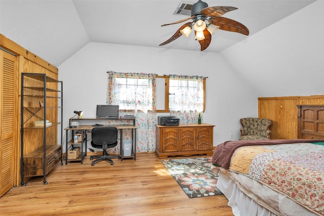 bedroom featuring ceiling fan, light hardwood / wood-style flooring, and lofted ceiling