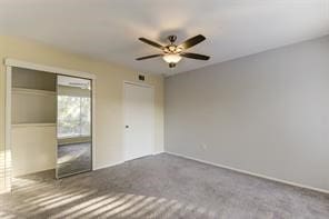 unfurnished bedroom with ceiling fan and carpet flooring