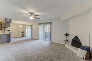 unfurnished living room featuring light carpet and ceiling fan