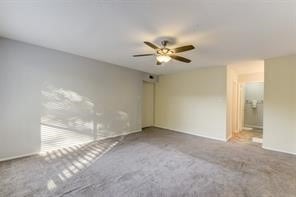 empty room featuring carpet and ceiling fan