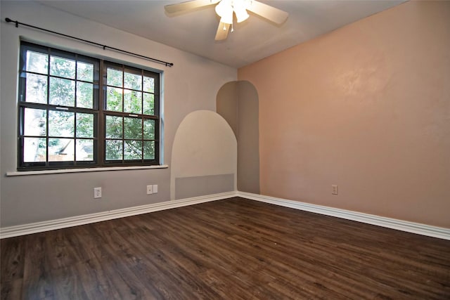 empty room featuring ceiling fan, plenty of natural light, and hardwood / wood-style floors