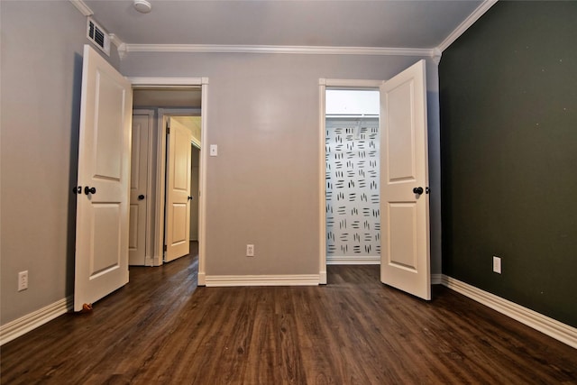 unfurnished bedroom featuring dark hardwood / wood-style floors and crown molding