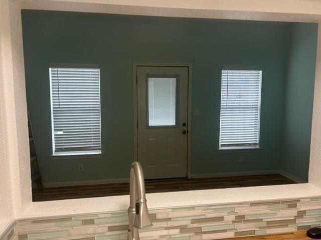 entrance foyer with baseboards and wood finished floors