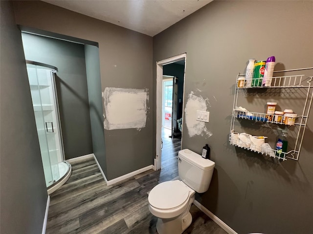 17102 River Rd, Channelview, TX 77530 - bathroom with a shower stall, toilet, wood finished floors, and baseboards