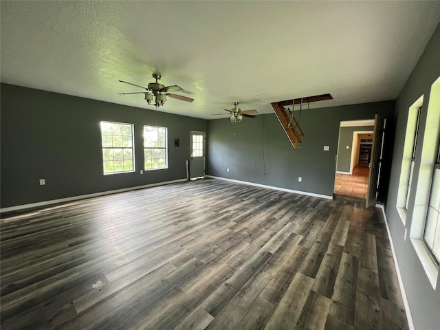 17102 River Rd, Channelview, TX 77530 - unfurnished living room with dark wood finished floors, a ceiling fan, and baseboards