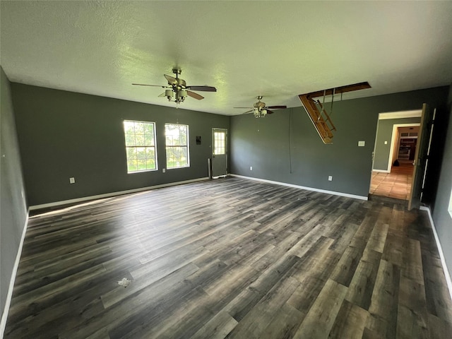 17102 River Rd, Channelview, TX 77530 - unfurnished living room featuring a ceiling fan, baseboards, dark wood-style flooring, and a textured ceiling