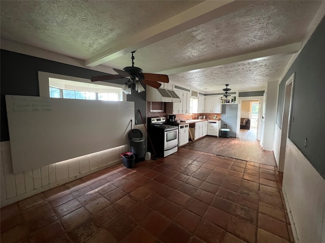 kitchen featuring beam ceiling, a healthy amount of sunlight, white cabinetry, and stainless steel appliances