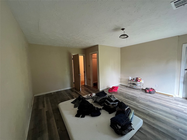 interior space with wood-type flooring and a textured ceiling