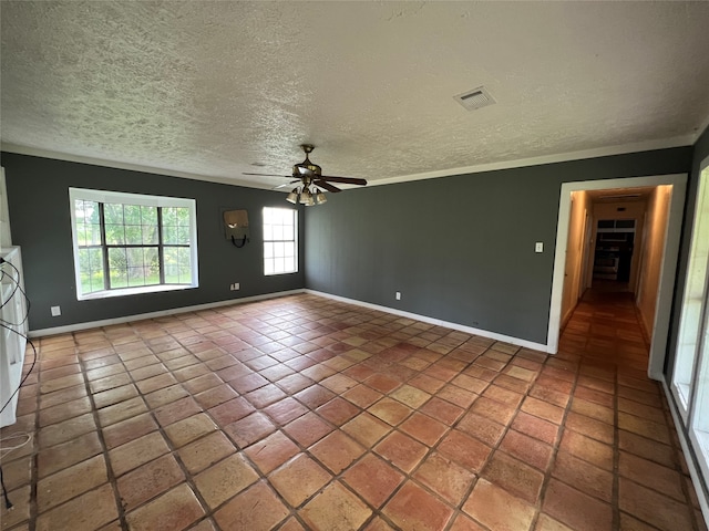 tiled empty room with crown molding, a textured ceiling, and ceiling fan