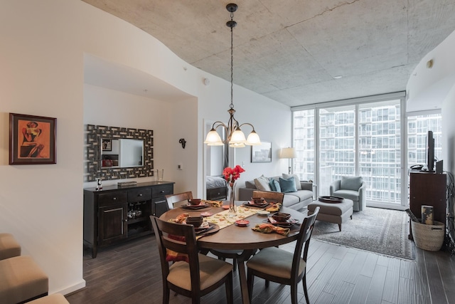 dining space with an inviting chandelier, expansive windows, and dark wood-type flooring