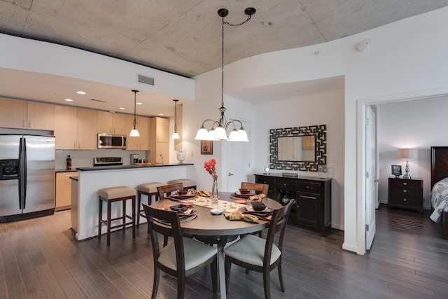 dining room with dark hardwood / wood-style floors, an inviting chandelier, and sink