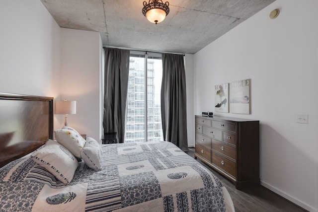 bedroom featuring dark hardwood / wood-style floors and floor to ceiling windows