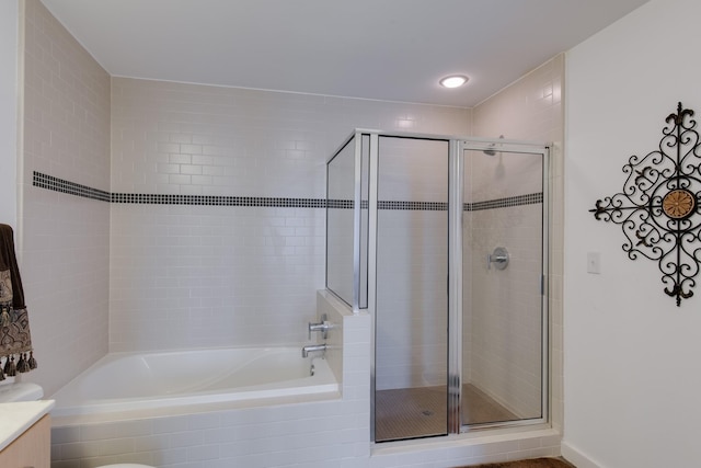 bathroom featuring vanity and shower with separate bathtub