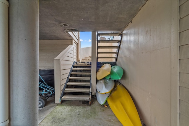 stairway featuring concrete flooring