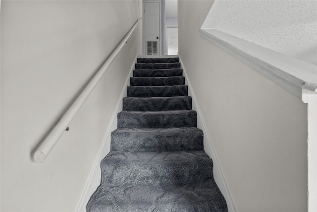 stairs featuring carpet