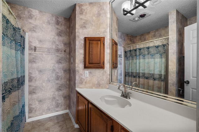 bathroom featuring a shower with curtain, tile patterned floors, a textured ceiling, and vanity