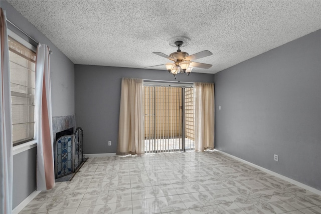 unfurnished living room with a textured ceiling and ceiling fan